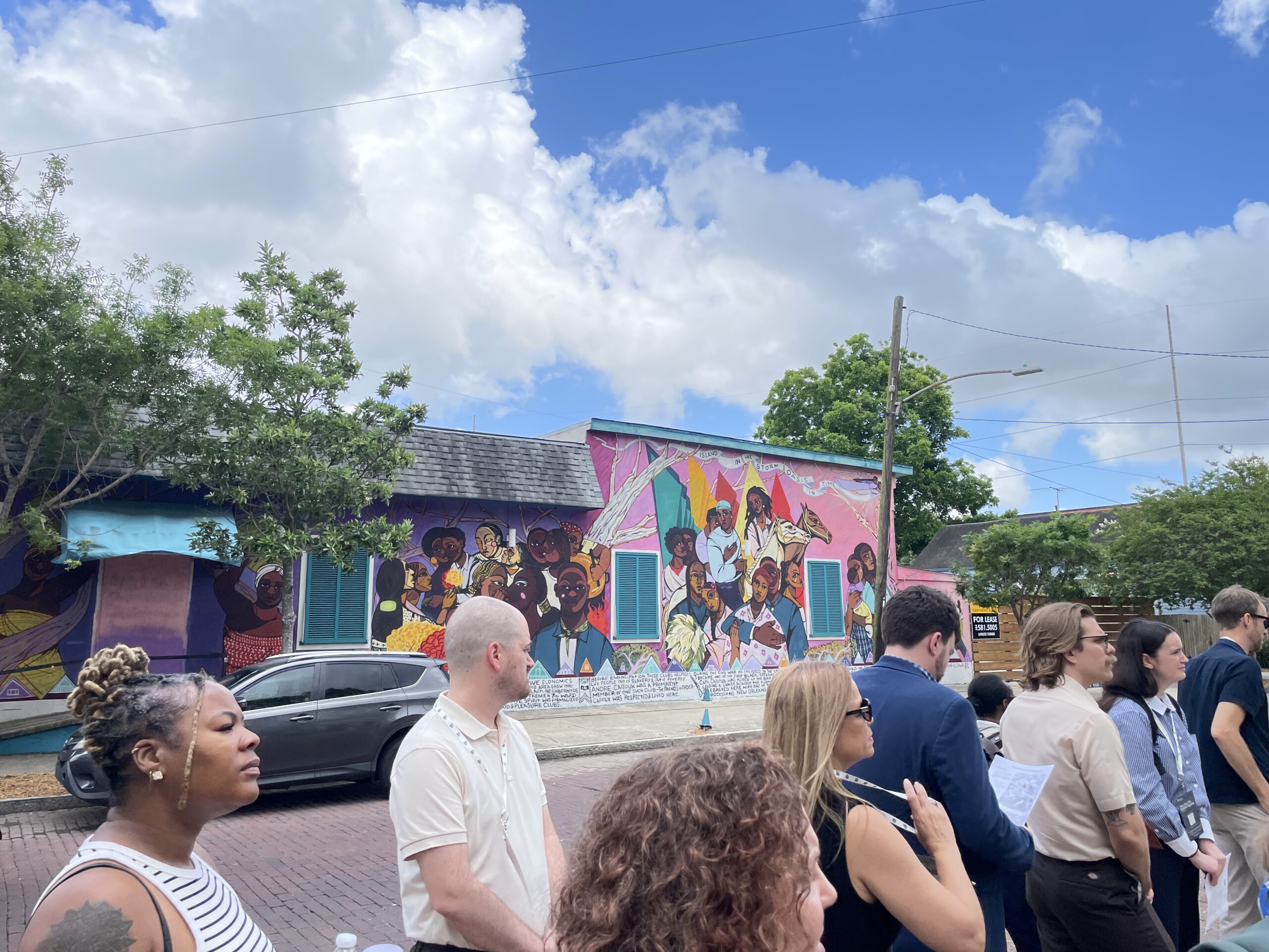 People outside in front of mural during Cityscapes tour of Bayou Road